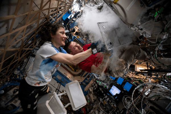 astaonauts andrew morgan and christina koch prepping samples for cold stowage